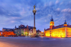 Panorama of Castle Square with Royal Castle, colorful houses and Sigismund Column called Kolumna Zygmunta in Old town during morning blue hour, Warsaw, Poland.